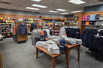 Pepperdine campus store clothes on tables and shelves