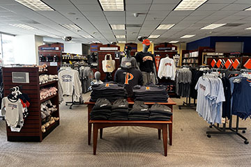 Pepperdine campus store with clothes on tables and hangers