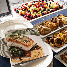 food assortment on serving plates and cookbook