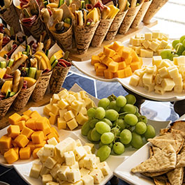 fruit and cheeses and appetizers on serving plates