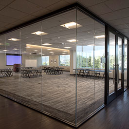 Pepperdine Calabasas Campus event space with window views and presentation screen and tables and chairs set up