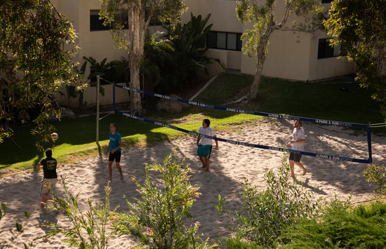 Students playing volleyball near the dorms