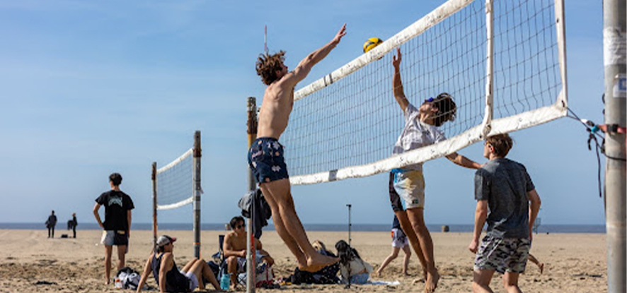 Pepperdine student in a beach volleyball match