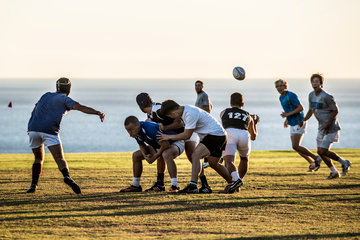 Students playing rugby in Alumni Park