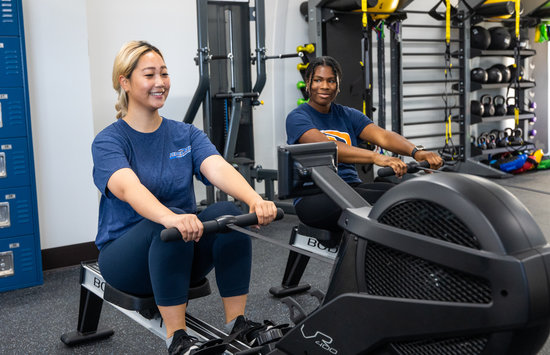 Students on the rowin machine in the fitness center