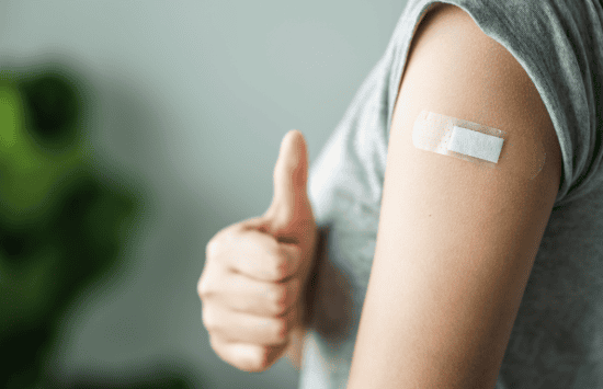 Person receiving a vaccine.