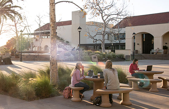 Picture of students sitting at a table on main campus.
