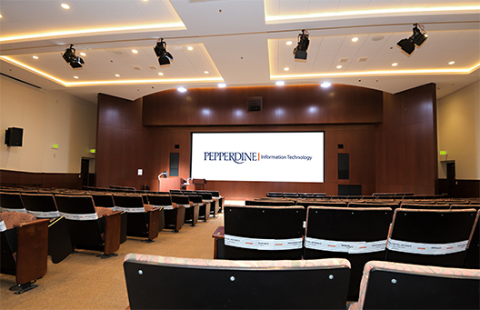 Large lecture and performance space with a full built-in screen at the front