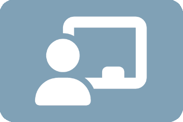 An instructor stands in front of a chalkboard to teach.