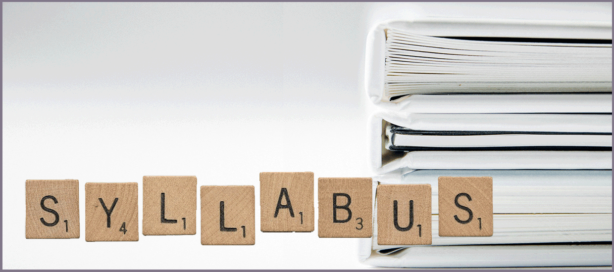 Syllabus spelled with Scrabble tiles with books in background