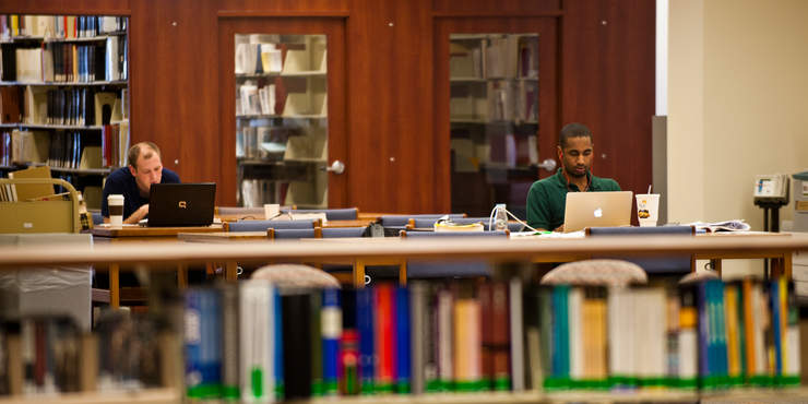 Students on laptops in the Harnish Law Library