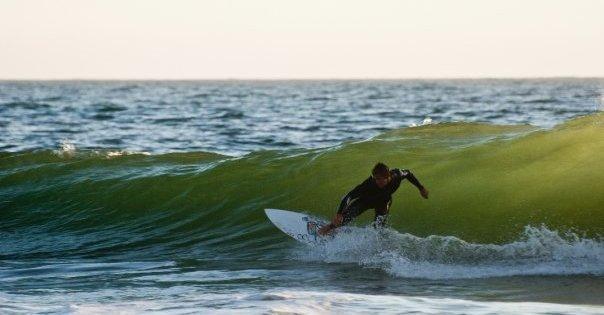 Student surfer captured riding a Wave at a beach in Malibu, Ca