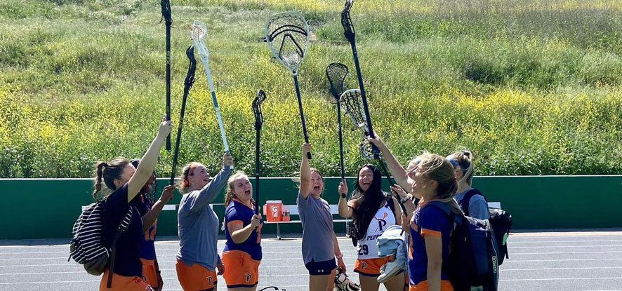 Seaver lacrosse club players holding their lacrosse stick