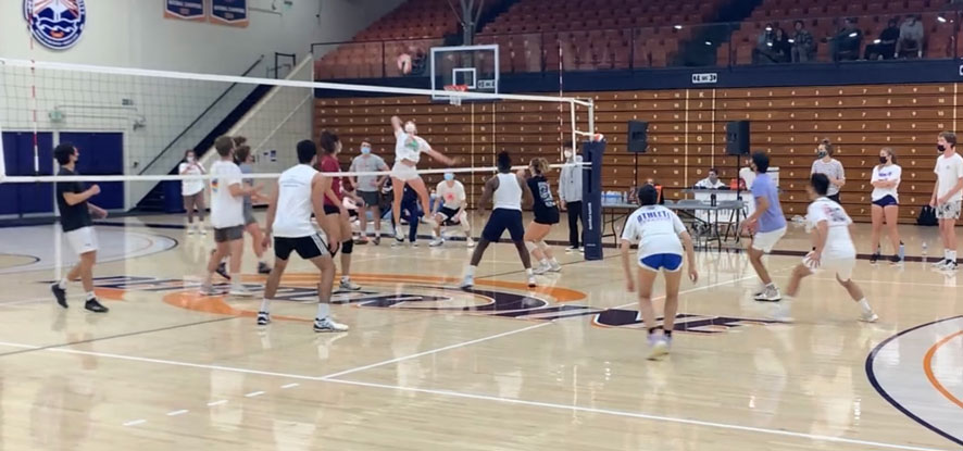 Pepperdine intramural team spking the volleyball during a match.