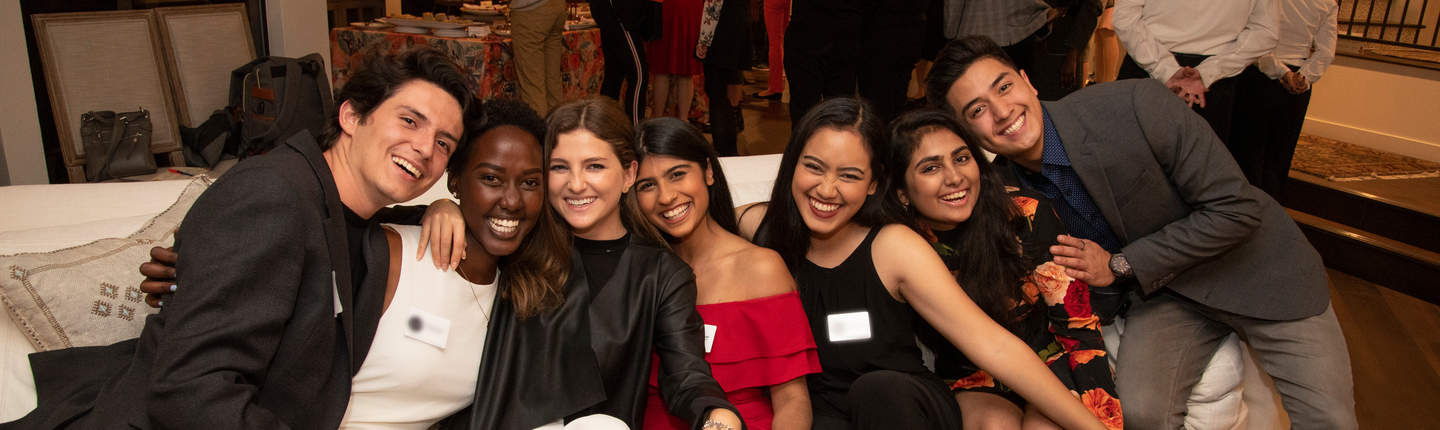 International students at an event, sitting on a couch together
