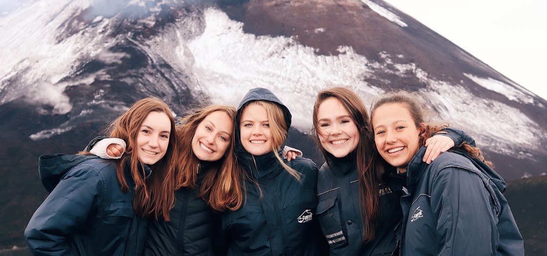 students in front of a mountain