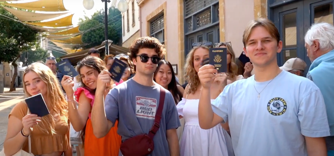 students holding passports