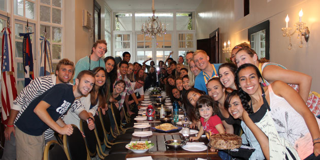 Seaver students gathered around a long table, sharing a meal in Buenos Aires