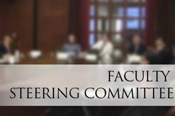The Technology & Learning Faculty Steering Committee sits at a conference room table at the Malibu campus.