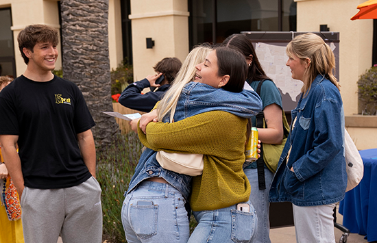 students hugging
